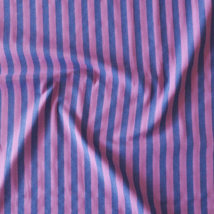 Purple and blue vertically striped fabric with a soft, draped texture.