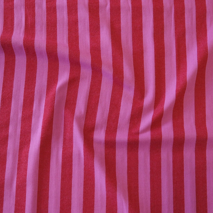Pink and red vertically striped fabric with a soft, slightly wrinkled texture.
