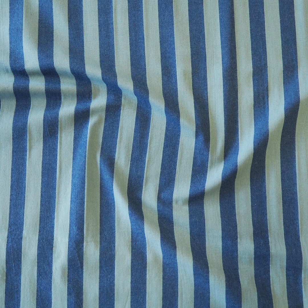 Navy and teal vertically striped fabric with a soft, draped texture.