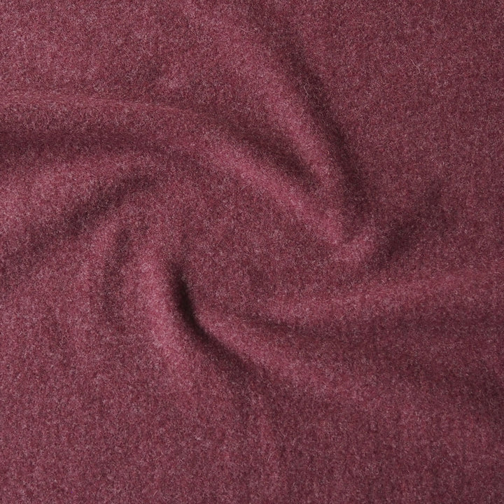 A close-up of heathered burgundy fabric with soft folds and a textured, slightly fuzzy surface.