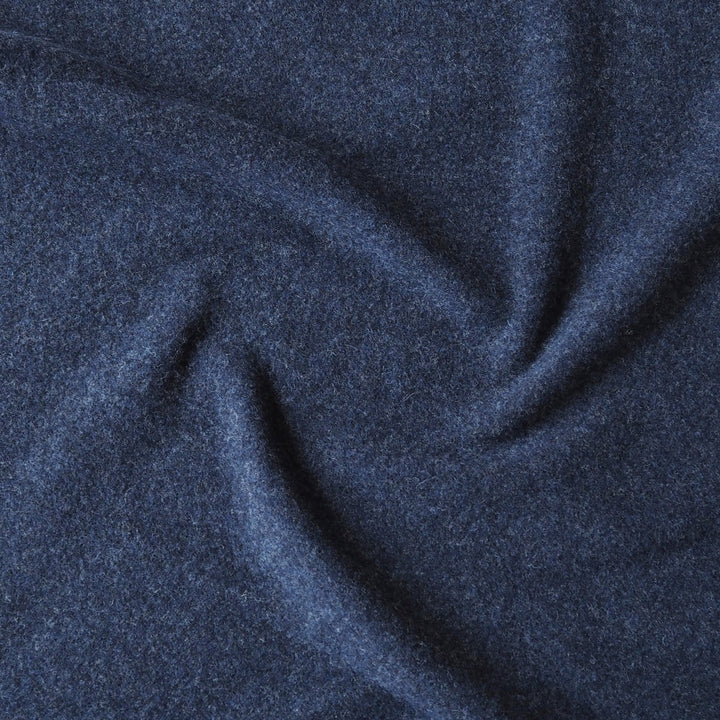 A close-up of dark navy blue textured fabric with soft folds and a heathered, slightly fuzzy surface.