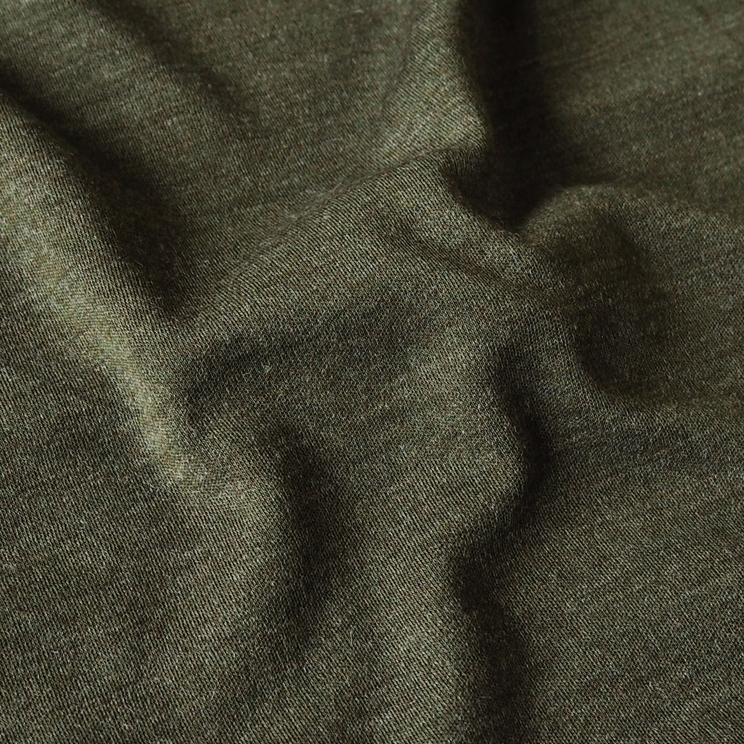 A close-up of dark olive green fabric with a fine textured weave and soft folds.