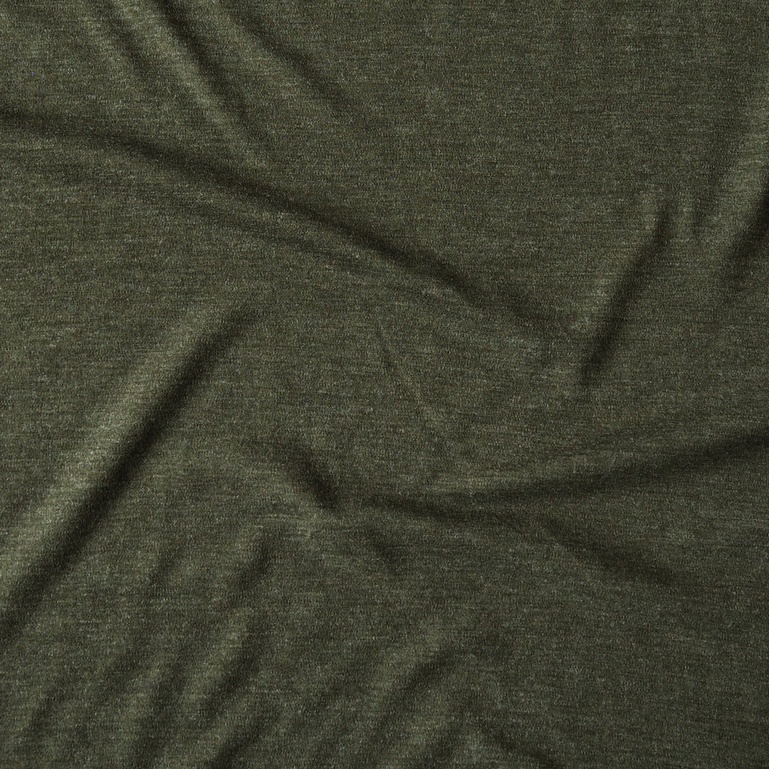 A close-up of dark olive green heathered fabric with soft folds and wrinkles.