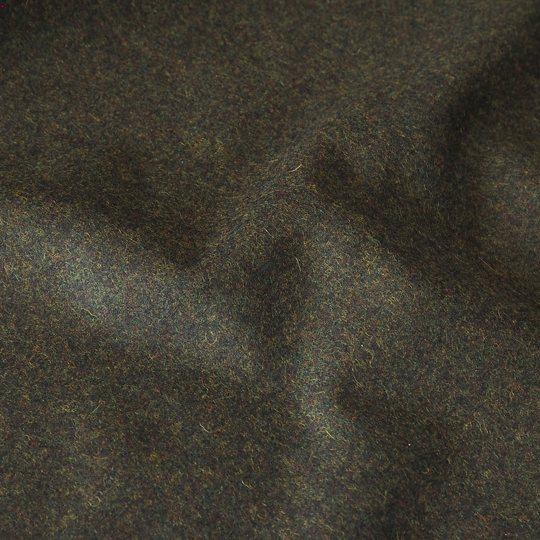 A close-up of dark green-brown wool fabric with a soft, textured surface and subtle folds.