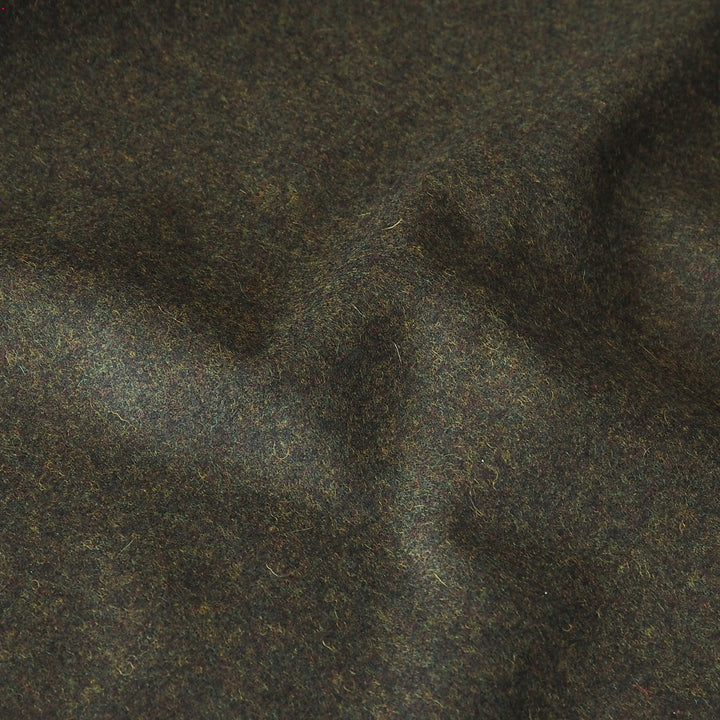 A close-up of dark green-brown wool fabric with a soft, textured surface and subtle folds.