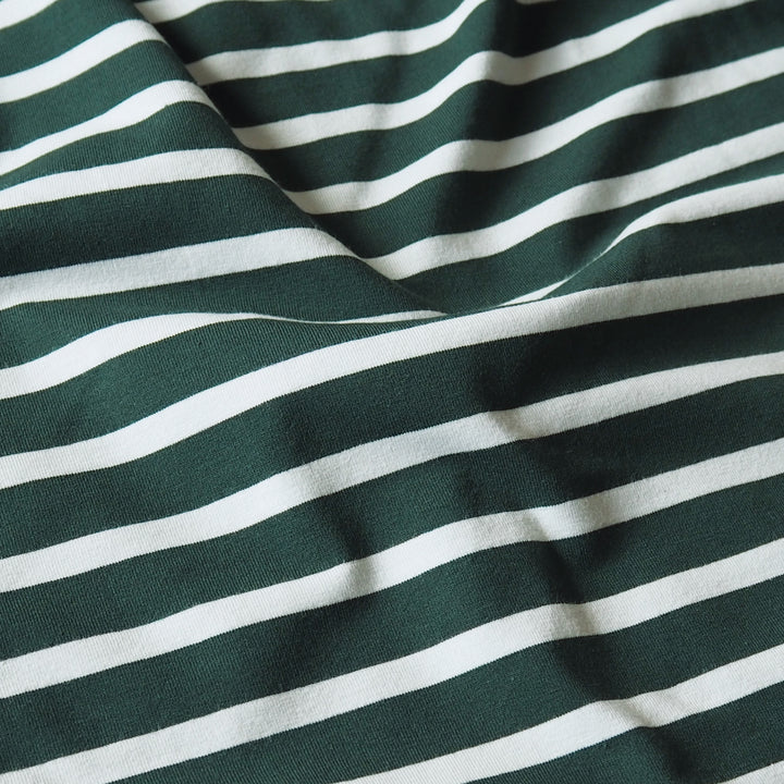 A close-up of a striped fabric with alternating dark green and mint horizontal bands, shown with soft folds and texture.