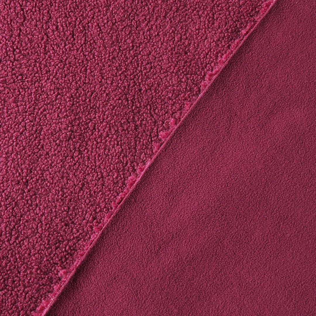 A close-up of a plush, textured fabric in a rich deep red color, showing two different pile textures divided diagonally by a clean edge.