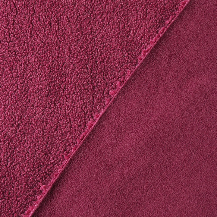 A close-up of a plush, textured fabric in a rich deep red color, showing two different pile textures divided diagonally by a clean edge.