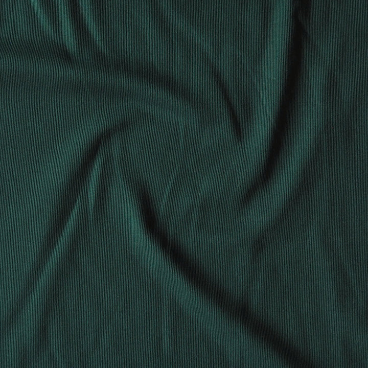 Dark green ribbed knit fabric with a textured vertical stripe pattern, shown draped with soft folds.