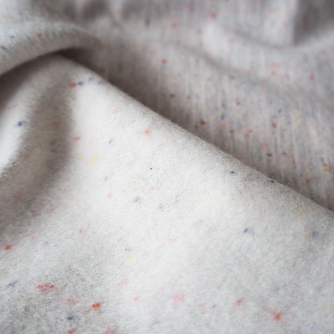 Light grey fleeceback sweatshirt fabric with colourful flecks.
