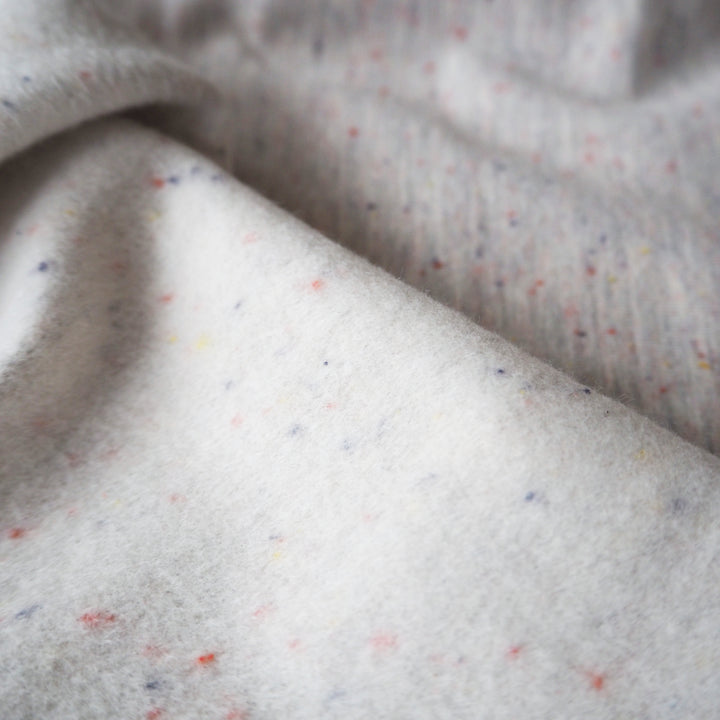 Light grey fleeceback sweatshirt fabric with colourful flecks.