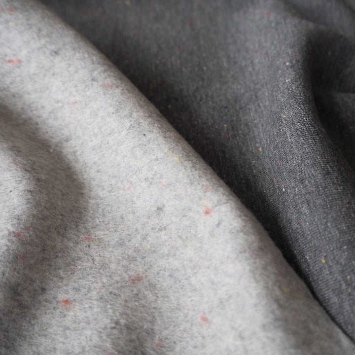 Dark grey fleeceback sweatshirt fabric with colourful flecks.