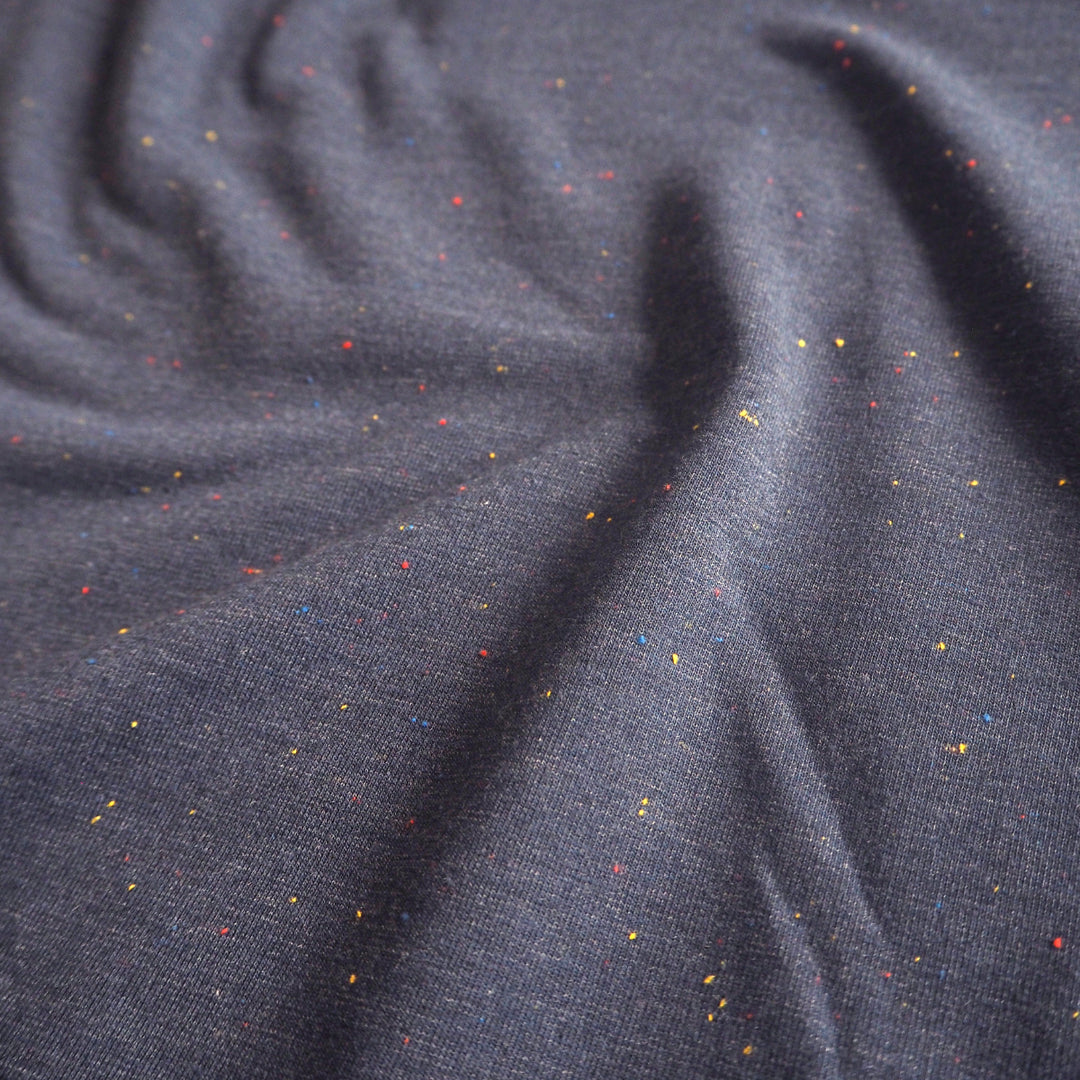 Denim blue fleeceback sweatshirt fabric with colourful flecks.