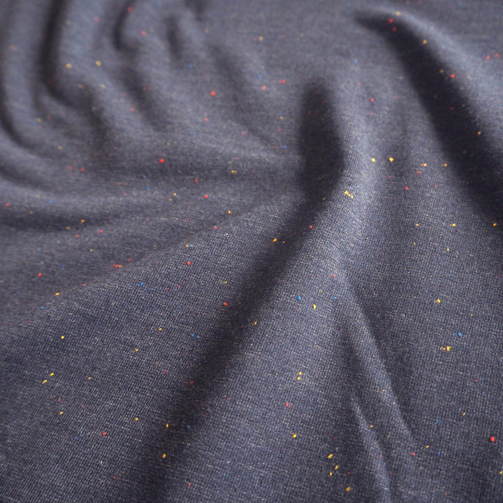 Denim blue fleeceback sweatshirt fabric with colourful flecks.