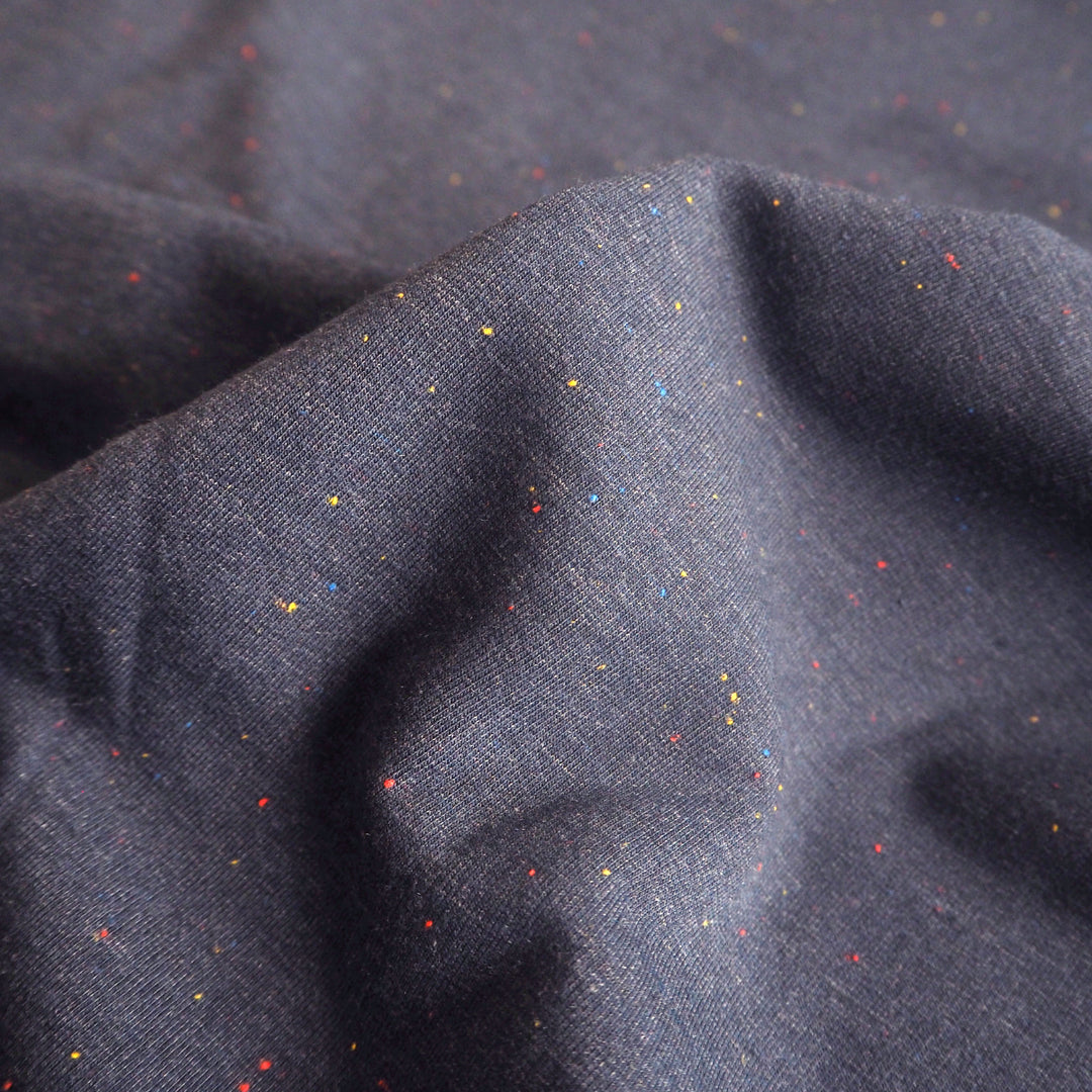 Denim blue fleeceback sweatshirt fabric with colourful flecks.