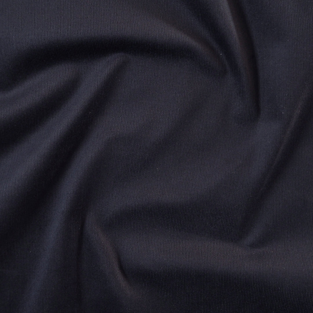 Navy blue stretch cotton needlecord fabric, fine soft cord.