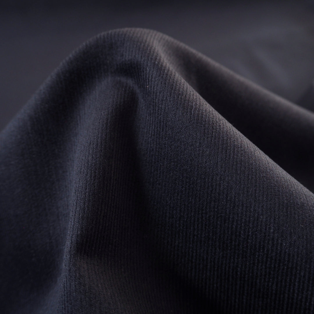 Navy blue stretch cotton needlecord fabric, fine soft cord.