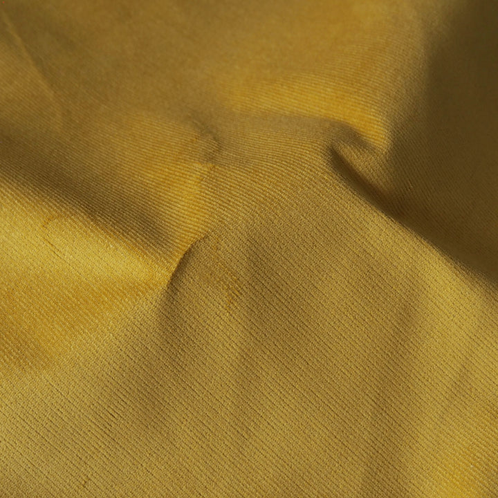 Mustard yellow stretch cotton needlecord fabric, fine cord texture.
