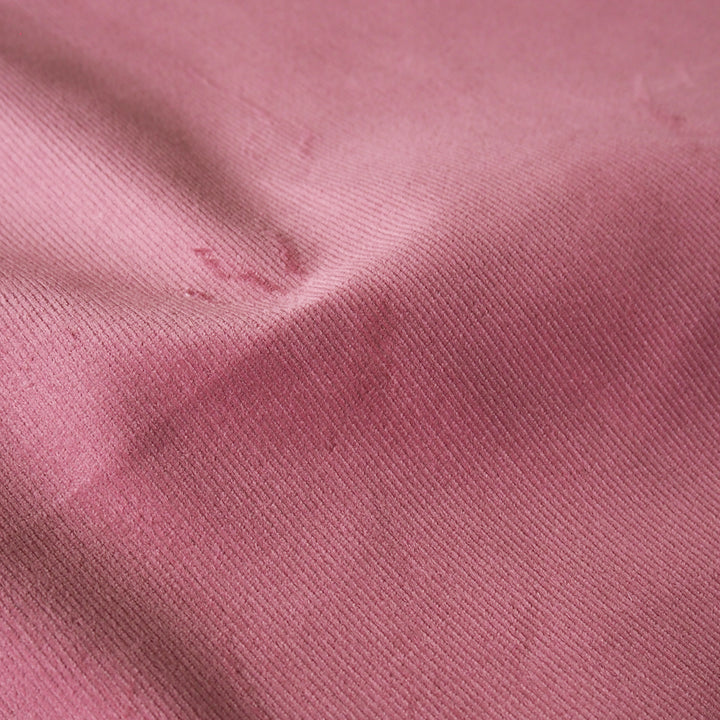 Carnation pink stretch cotton needlecord fabric, soft fine cord texture.