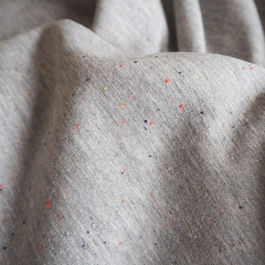 Silver grey fleeceback sweatshirt fabric with colourful flecks.