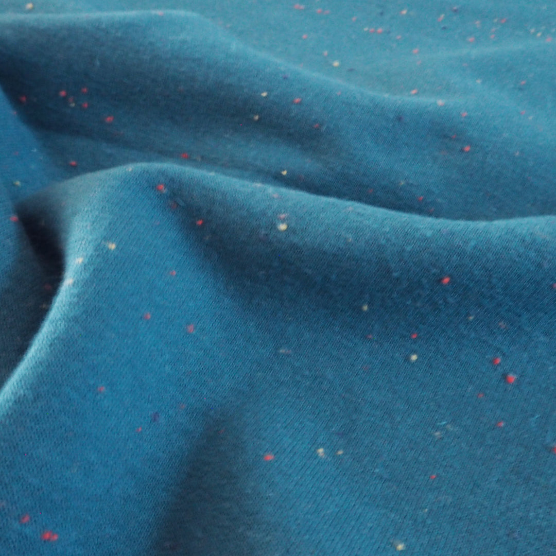 Peacock blue fleeceback sweatshirt fabric with colourful flecks.