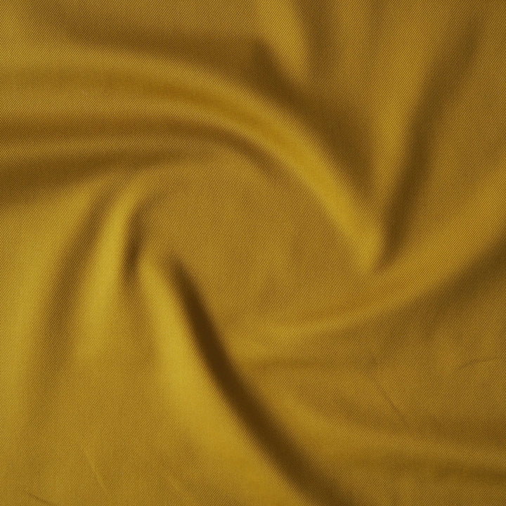 Sevenberry ochre yellow cotton twill drill fabric, perfect for dressmaking and other sewing projects.