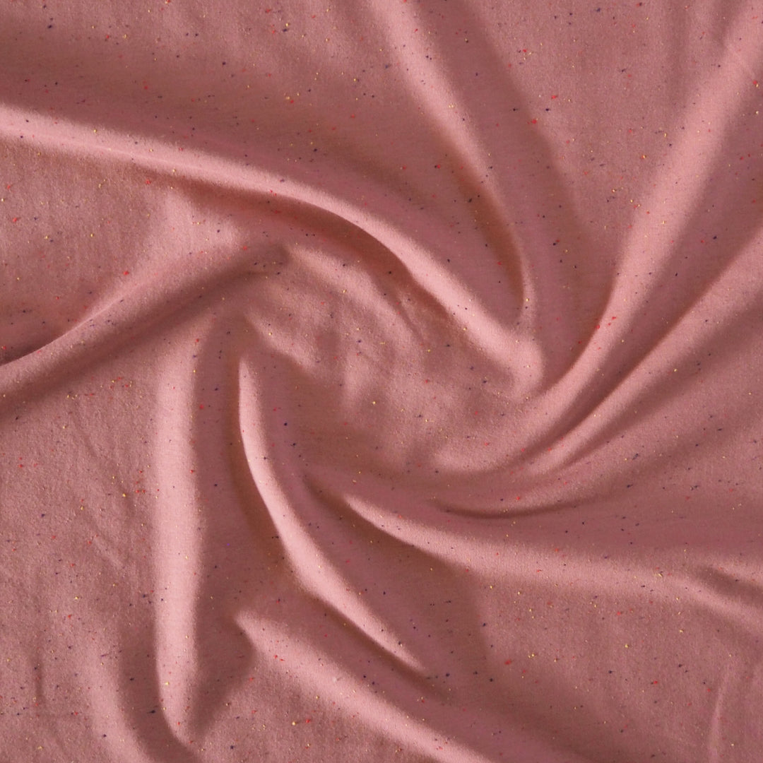 Rose pink cotton fleeceback sweatshirt fabric with multicoloured flecks.
