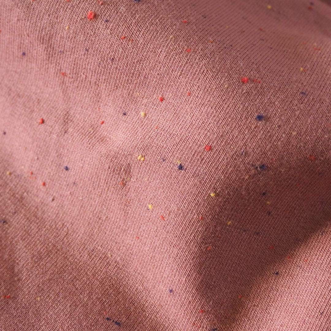 Rose pink cotton fleeceback sweatshirt fabric with multicoloured flecks.