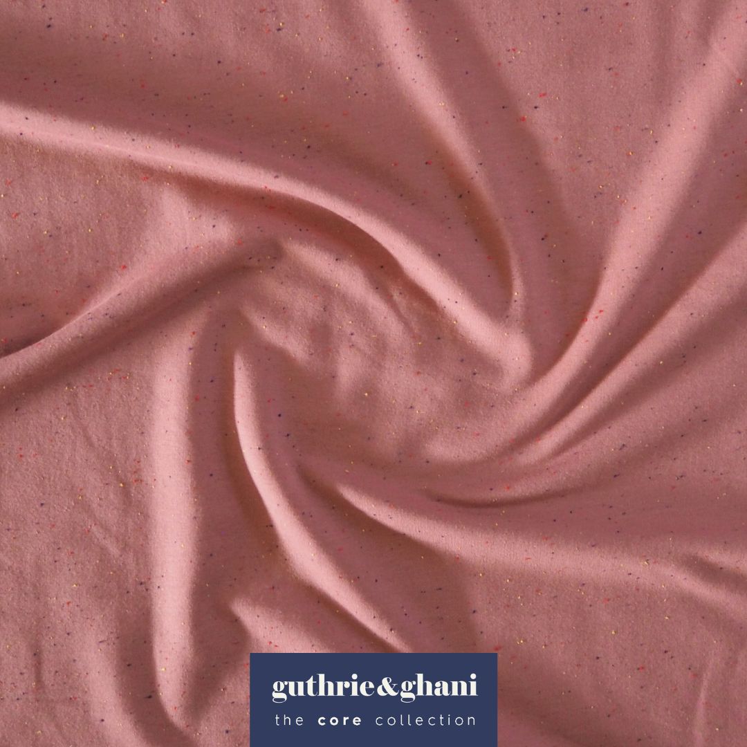 Rose pink cotton fleeceback sweatshirt fabric with multicoloured flecks.