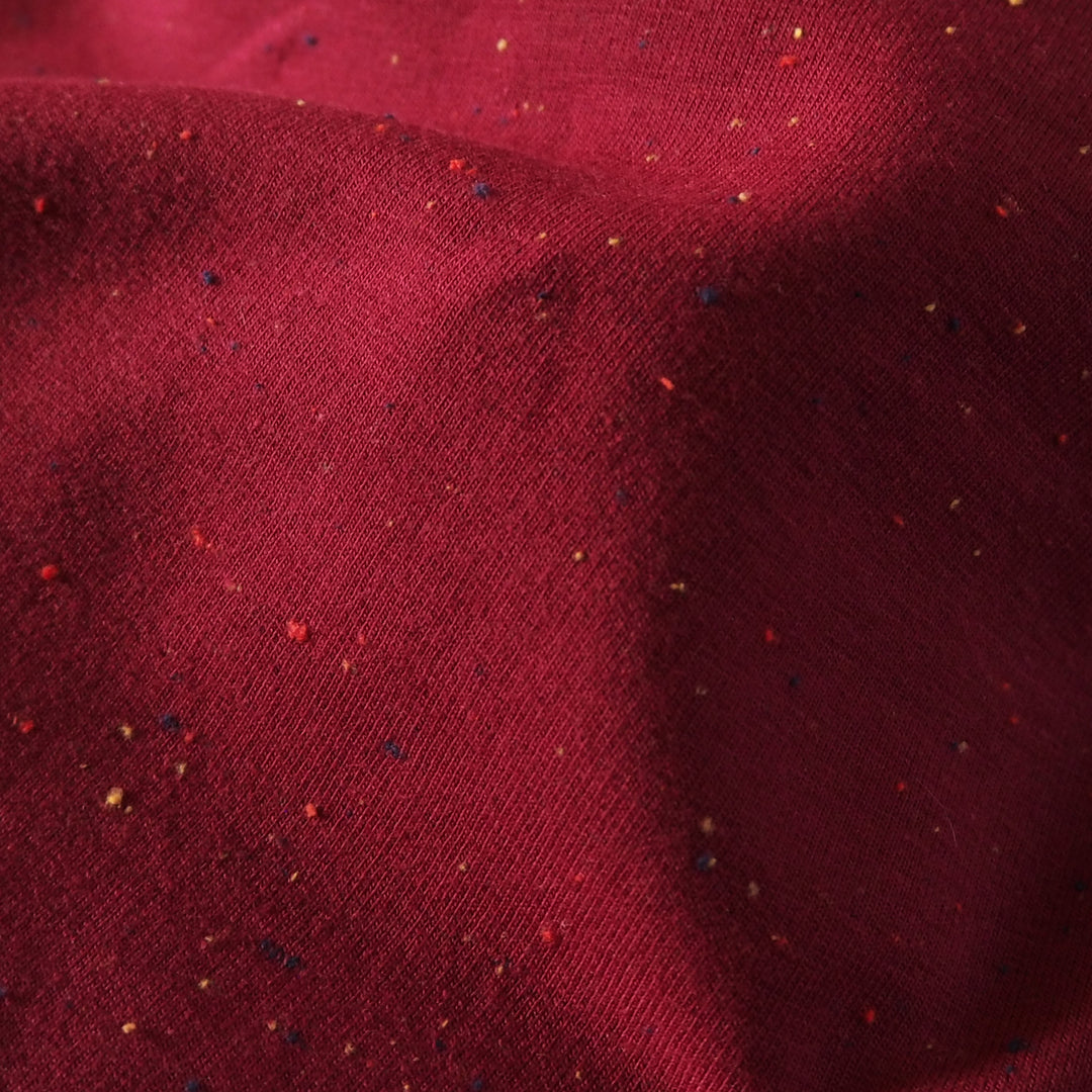 Berry fleeceback sweatshirt fabric with colourful flecks.