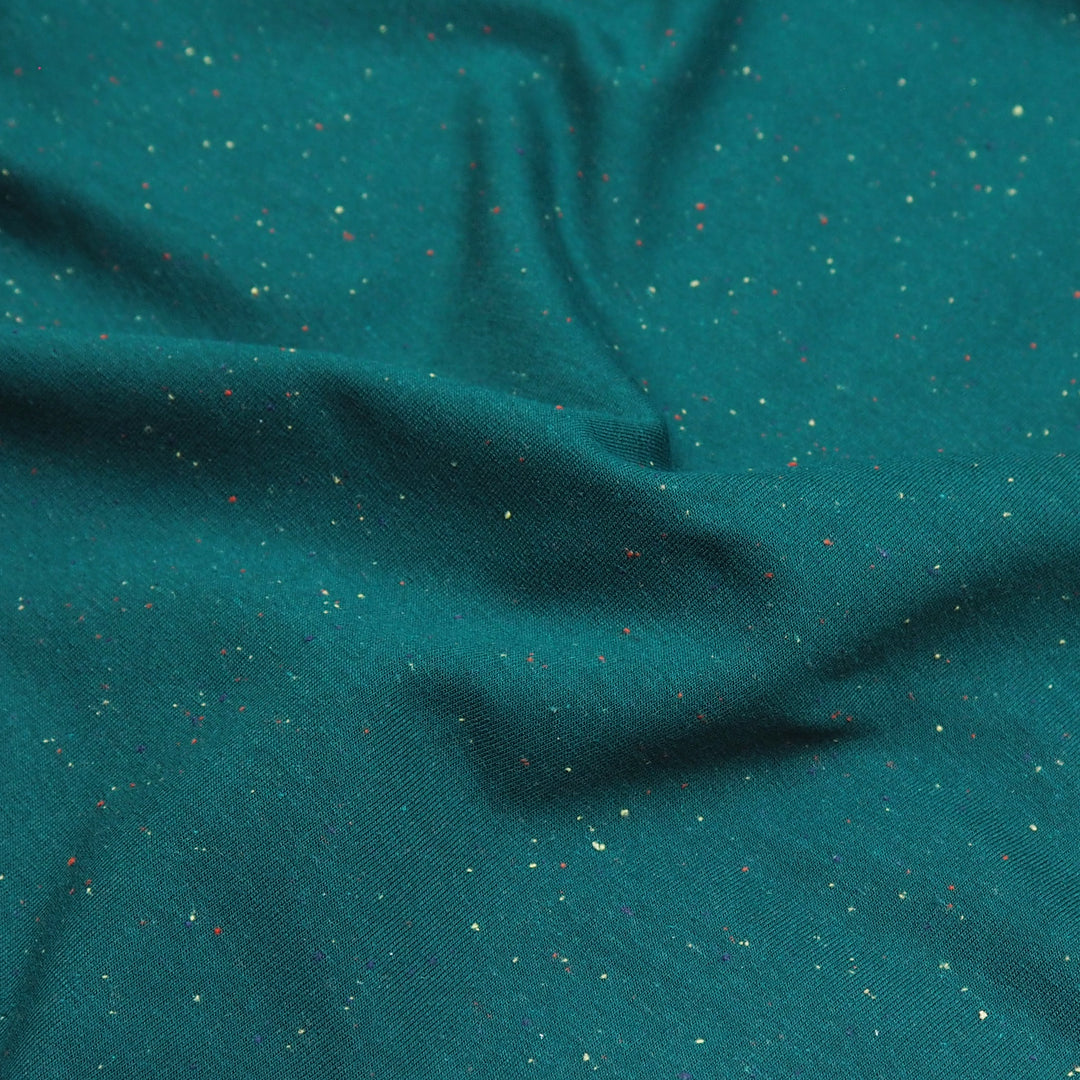 Emerald green fleeceback sweatshirt fabric with colourful flecks.