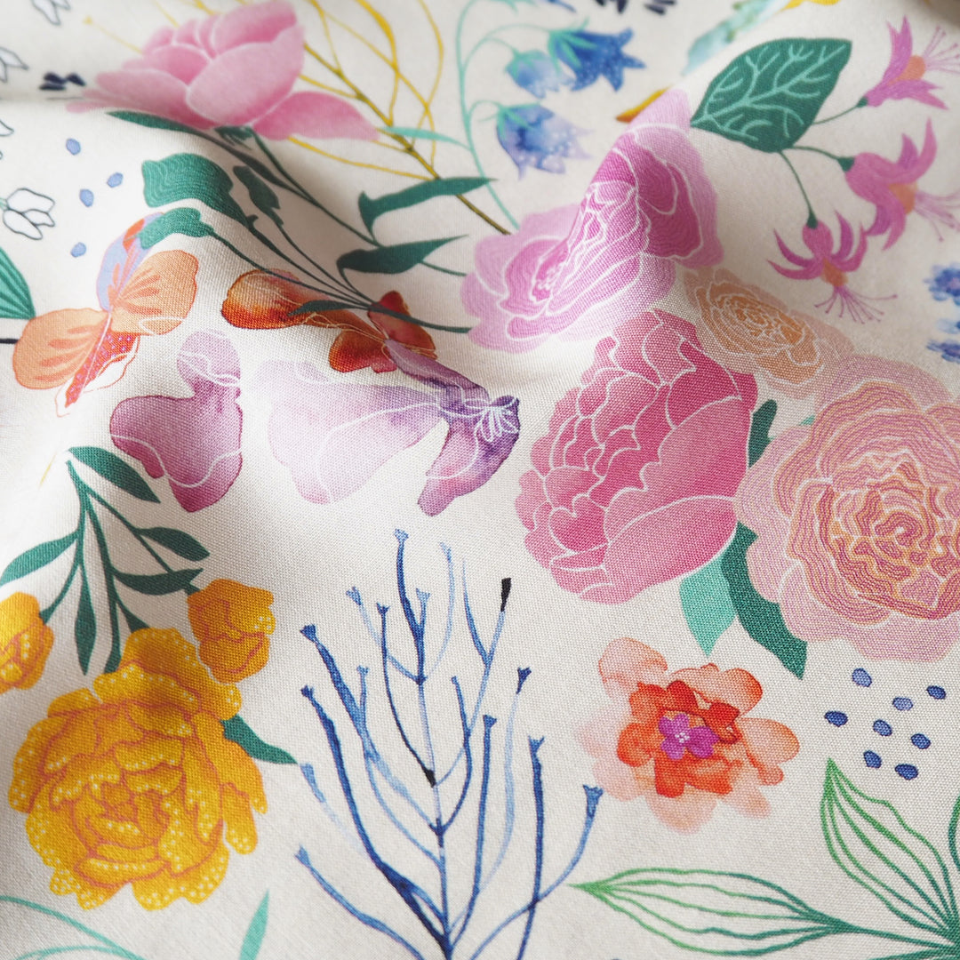 Cream Bee Happy Blooms Ecovero viscose fabric with floral and bee print, exclusive to Guthrie & Ghani.