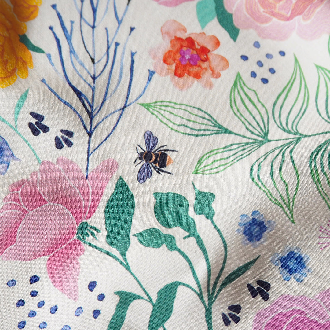 Cream Bee Happy Blooms Ecovero viscose fabric with floral and bee print, exclusive to Guthrie & Ghani.