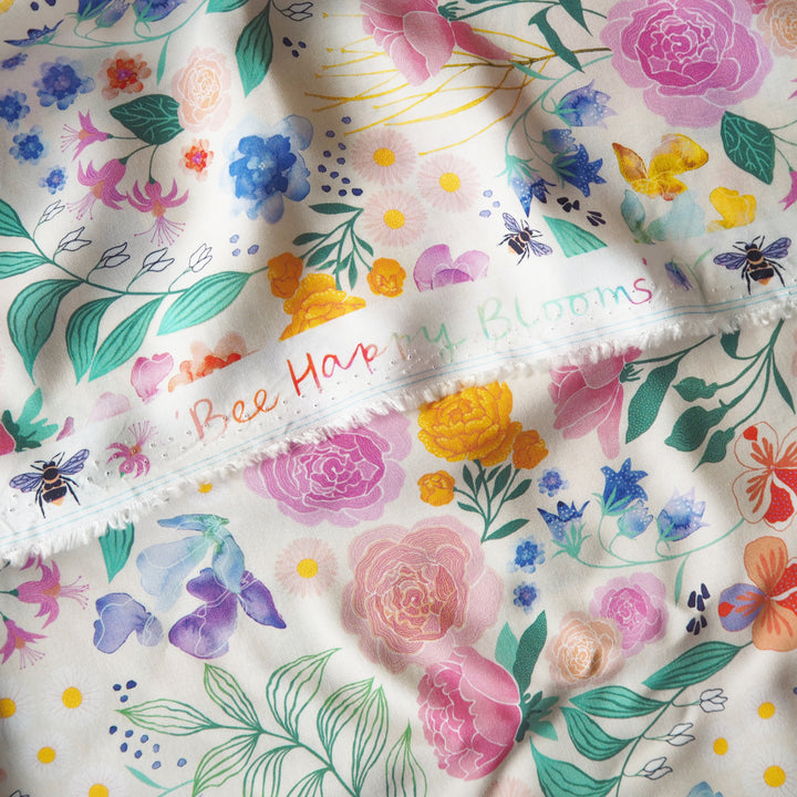 Cream Bee Happy Blooms Ecovero viscose fabric with floral and bee print, exclusive to Guthrie & Ghani.