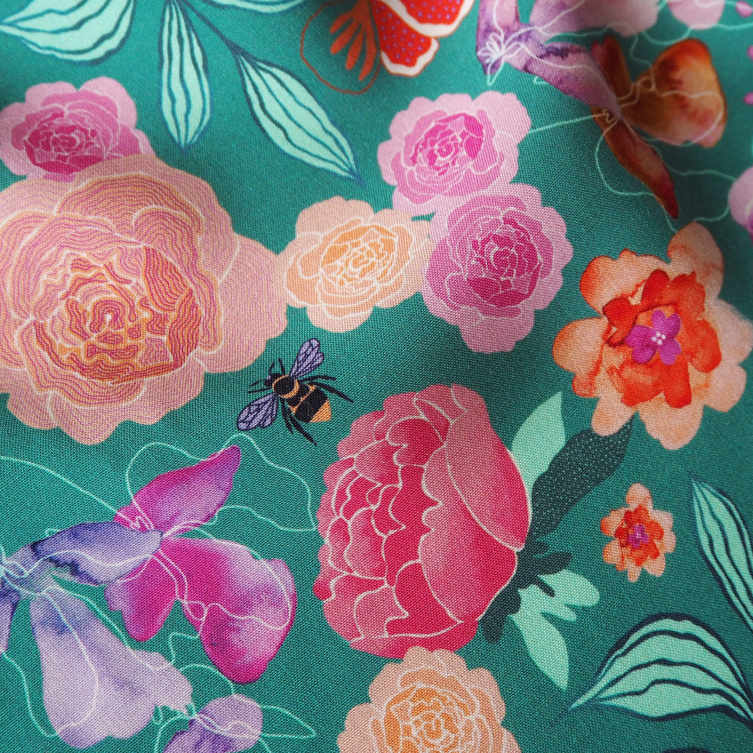 Teal Bee Happy Blooms Ecovero viscose fabric with floral and bee print, exclusive to Guthrie & Ghani.