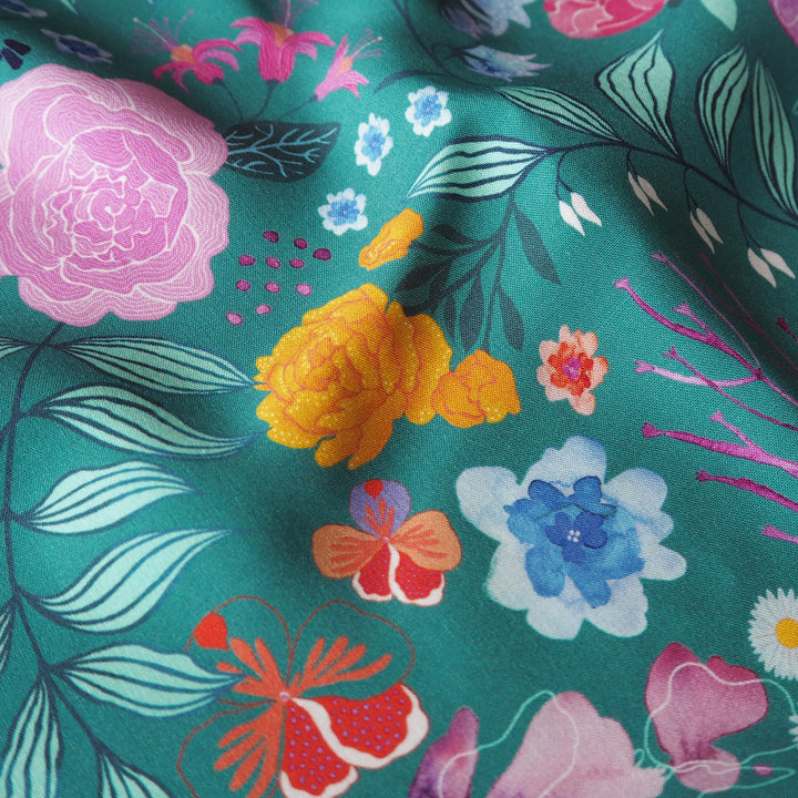 Teal Bee Happy Blooms Ecovero viscose fabric with floral and bee print, exclusive to Guthrie & Ghani.