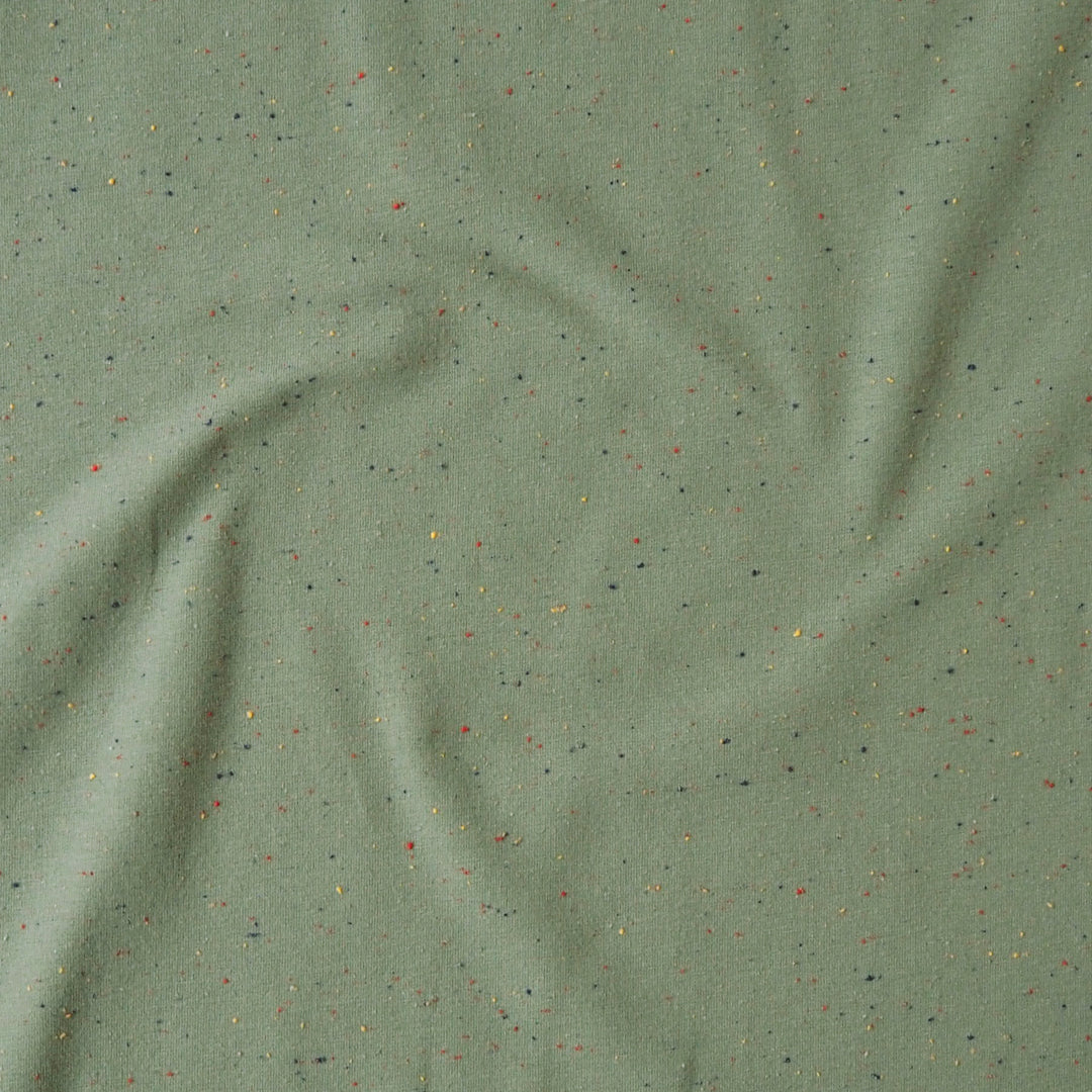 Sage green fleeceback sweatshirt fabric with colourful flecks.