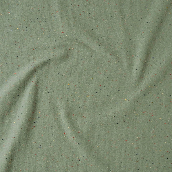 Sage green fleeceback sweatshirt fabric with colourful flecks.
