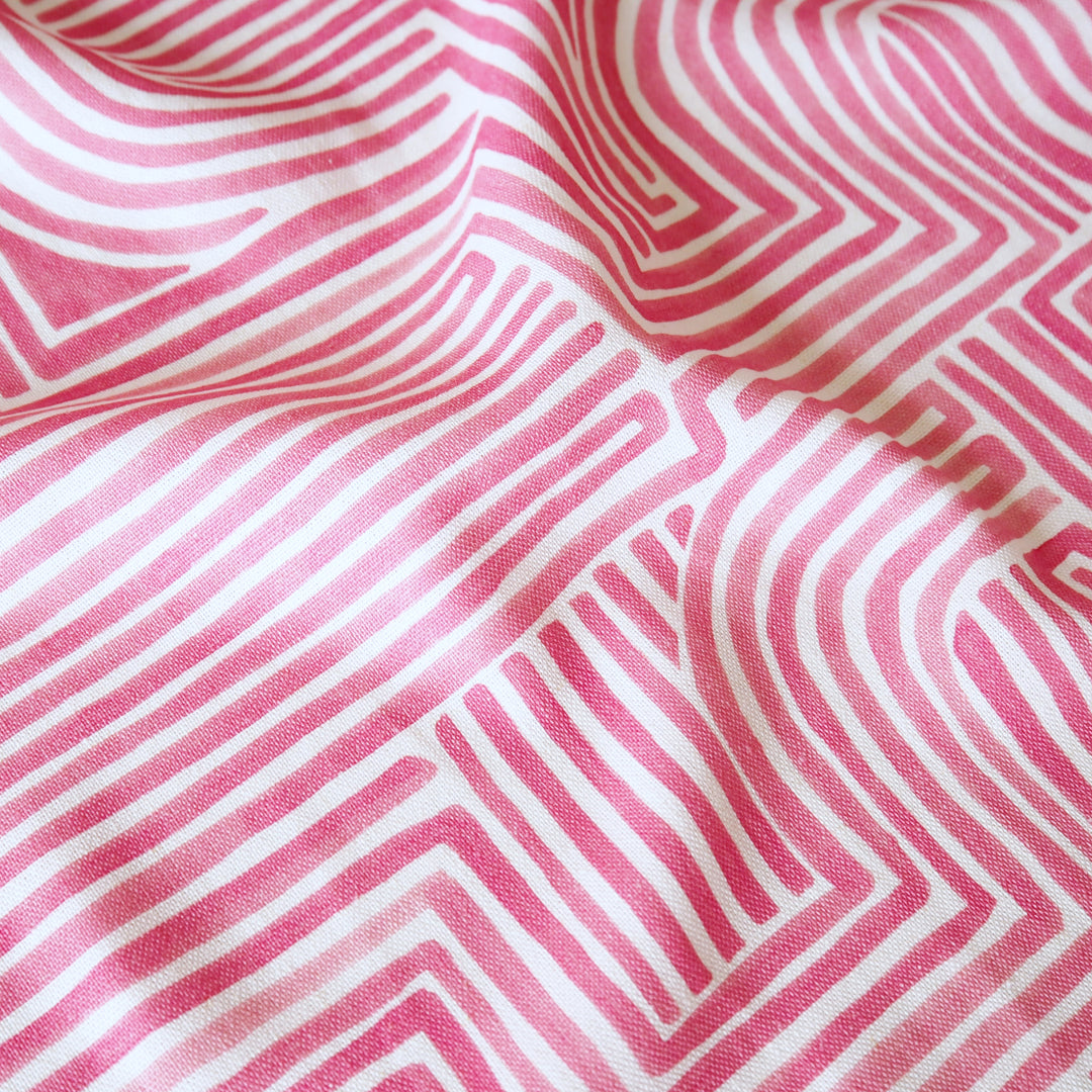 Close-up of pink and white striped fabric with geometric pattern