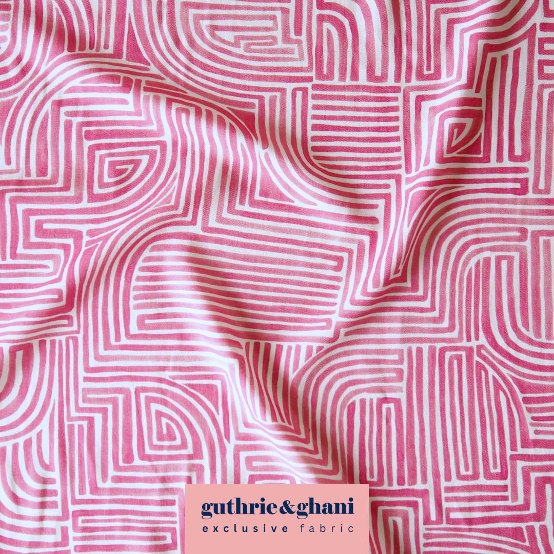 Pink fabric with white geometric pattern and 'guthrie & ghani' label