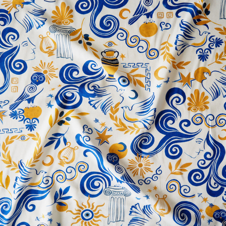 Decorative fabric with blue and yellow patterns on a white background
