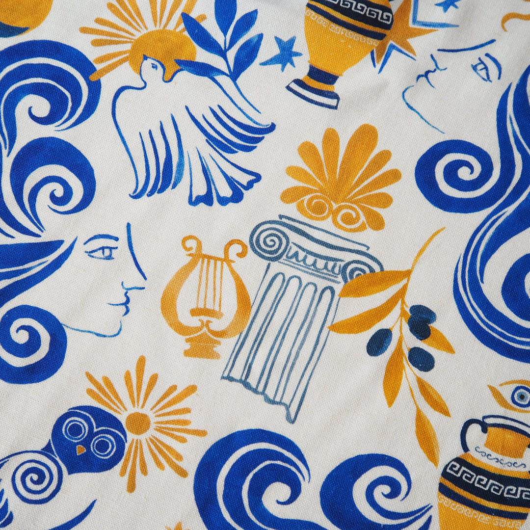 Patterned fabric with blue and orange designs on a white background