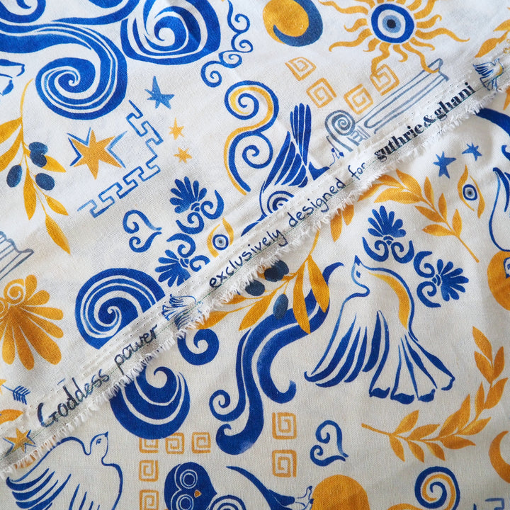 Close-up of fabric with blue and orange patterns and 'guthrie & ghani' branding.