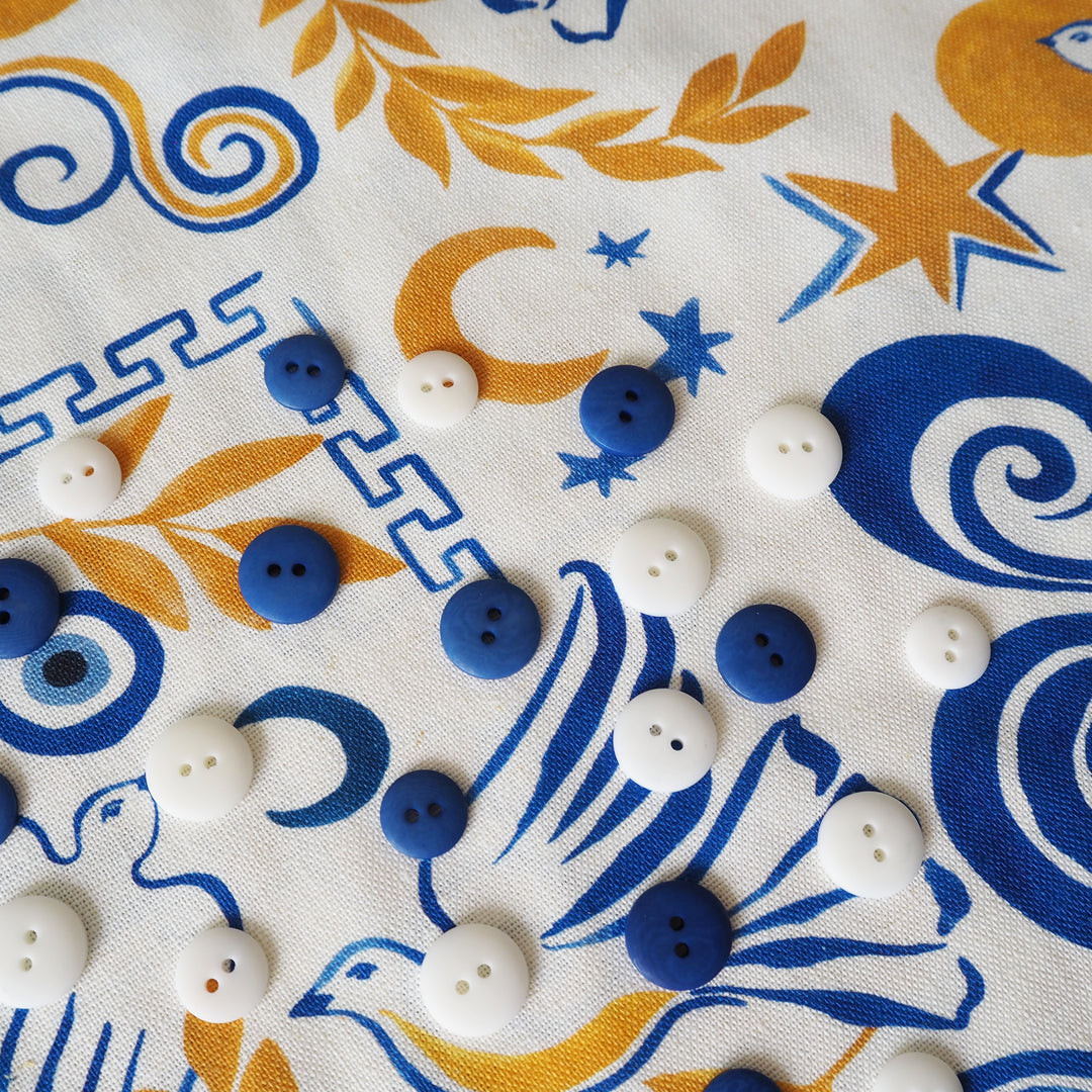 Buttons on a fabric with blue and yellow patterns