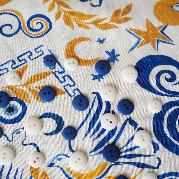 Buttons on a fabric with blue and yellow patterns