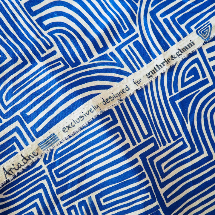 Blue and white geometric patterned fabric with a label