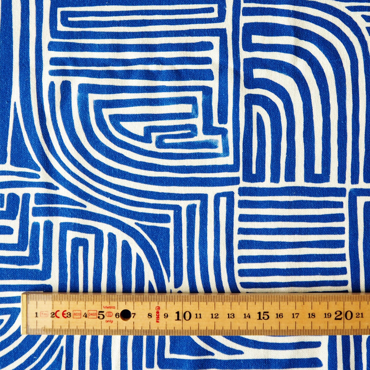 Blue and white geometric patterned fabric with a ruler for scale