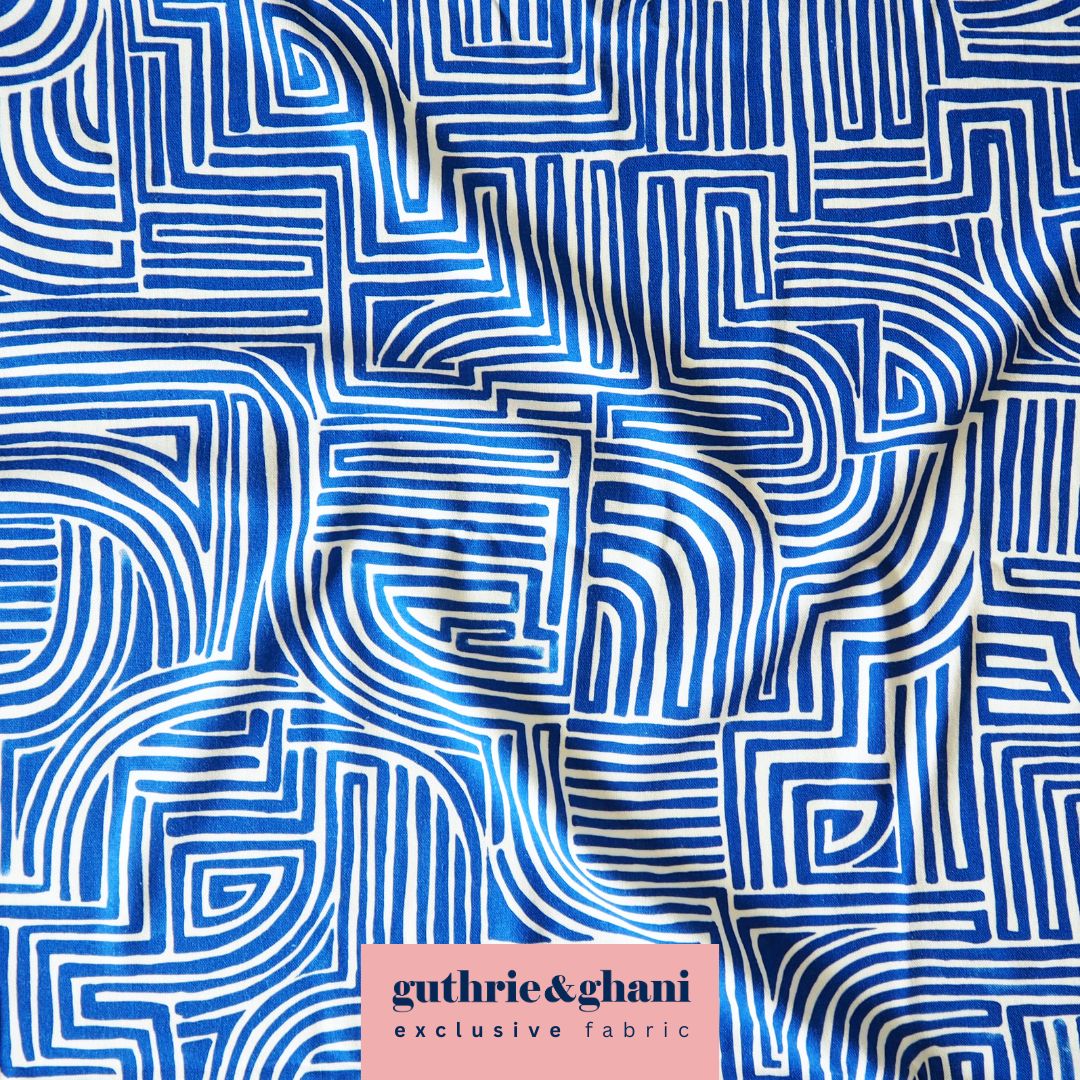 Fabric with blue and white geometric pattern, featuring the brand 'guthrie & ghani'.