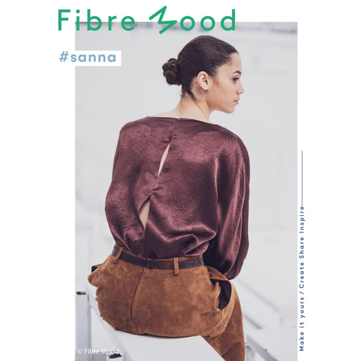 Woman wearing a brown outfit with 'Fibre Mood' branding on a white background