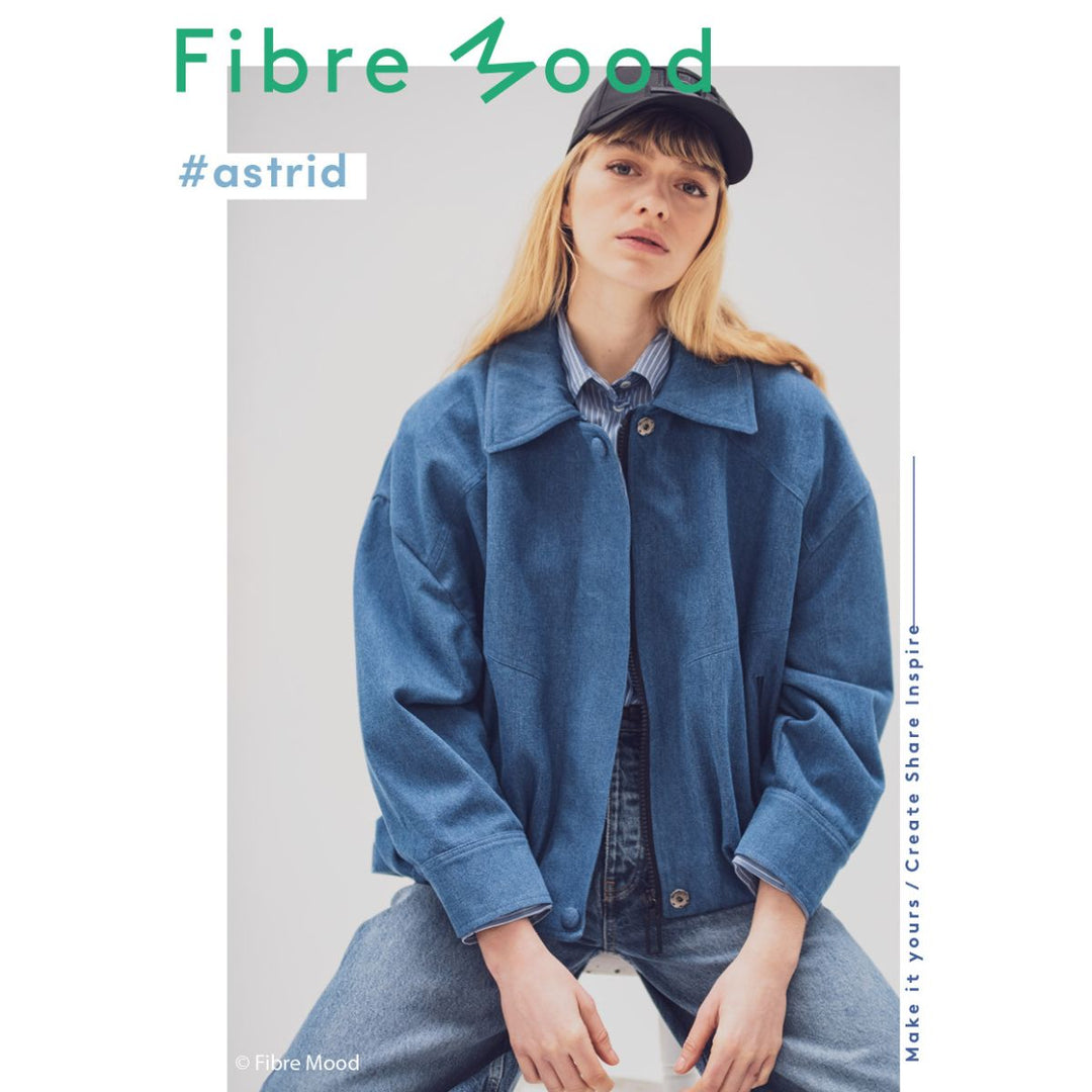 Person wearing a blue jacket and cap with 'Fibre Mood' branding.
